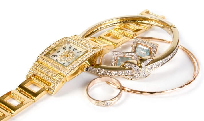 Golden clock and jewellery. Isolate on white background.